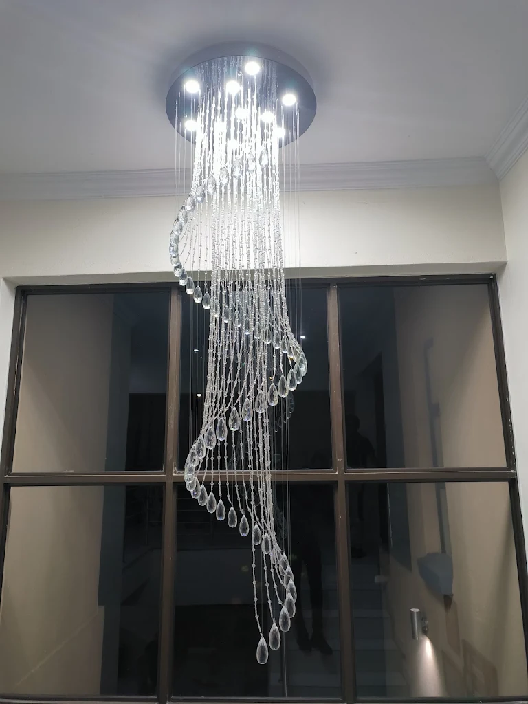 Large spiral crystal chandelier over a staircase
