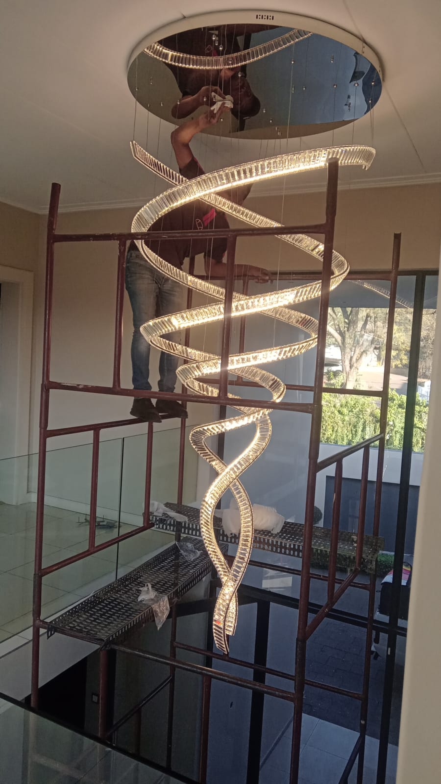 Modern spiral LED chandelier in a stairwell